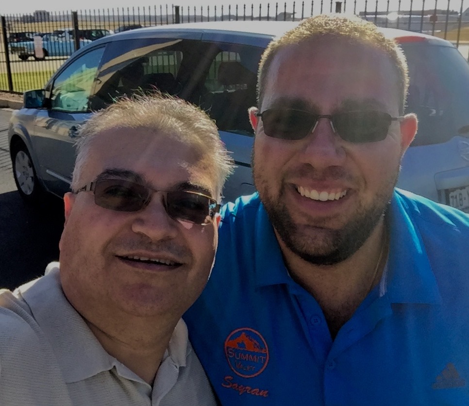 Sayran Hagop in his blue Summit Valet polo with a customer at a dealership lot